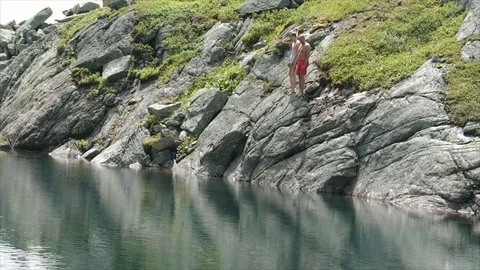 Swimming in a mountain lake 動画素材 83696496