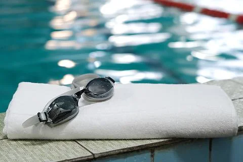 Swimming pool. accessory for the pool - a towel, swimming goggles. Stock Photos