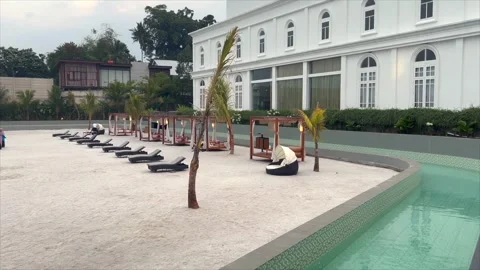 Swimming pool area with white sand and white building Video stock 333634857