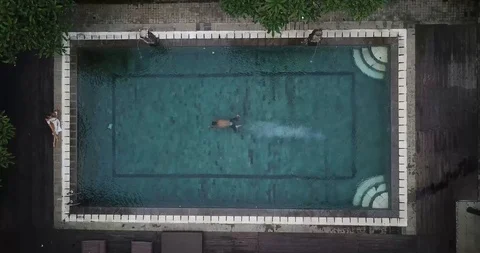 Swimming in Pool in Bali Top Down Drone Shot Stock Footage 106095656