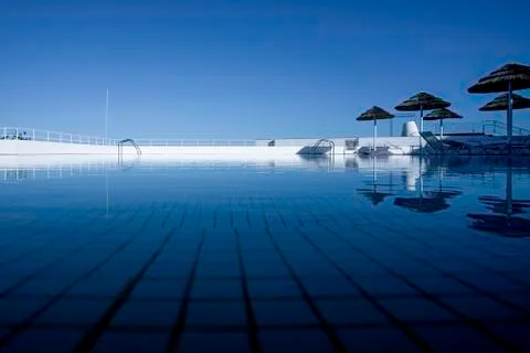 Swimming pool with blue sky reflection Stock Photos