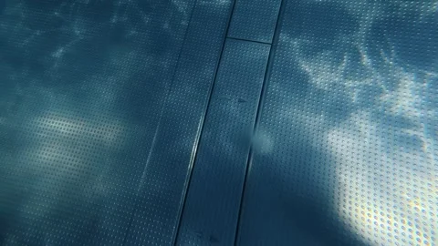 Swimming pool bottom with sunlight rippling across textured surface Stock Footage 342048604