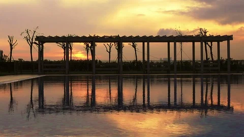 Swimming pool in the evening at sunset Stock Footage 100303177