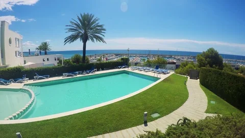 Swimming pool in front of house with nature and harbor in the background - sunny Stock Footage