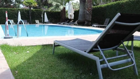 Swimming Pool in the Garden. Beautiful Blue Water Swimming Pool Surrounded. Stock Footage 201879571