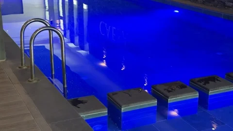 Swimming pool with glowing blue lights and modern design elements, ideal fo.. Stock Footage 336208238