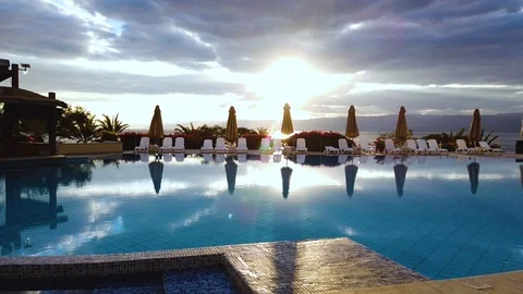 Swimming pool in the hotel against the backdrop of a beautiful sunset. Stock Footage 123601522