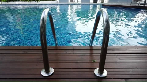 Swimming pool ladder with blue pool background Stock Footage 51213613