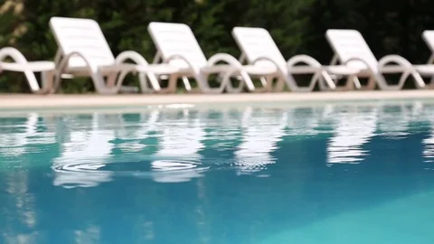 Swimming Pool with Lounge Chairs Stock Footage 84657239