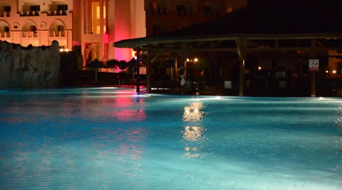 The swimming pool at luxury hotel in night illumination Stock Footage