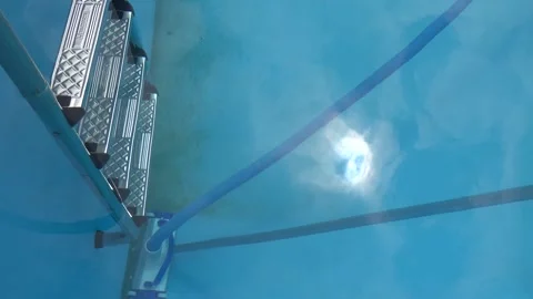 Swimming pool maintenance using a vacuum cleaner to remove dirt and algae f.. Stock Footage 341755079