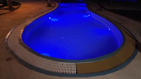 Swimming pool with multi-colored lighting Video stock 309128938