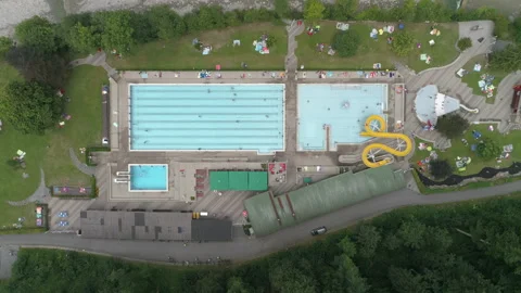 Swimming pool near the forest. Drone view Stock Footage 266887700