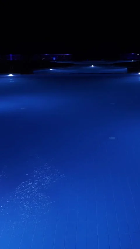 Swimming pool at night. close-up. pool water, blue backlit, at night Stock Footage 320346642
