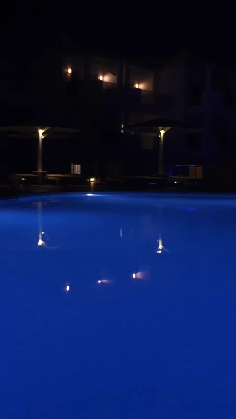Swimming pool at night. pool water, blue backlit, at night Stock-Footage 313797737