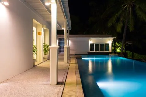 Swimming pool at night time Stock Photos