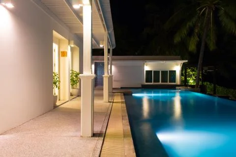 Swimming pool at night time Stock Photos
