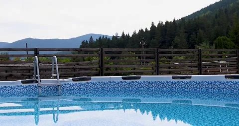 Swimming Pool Overlooking the Mountains. Panoramic View of the Pool  Stock Footage 248526267