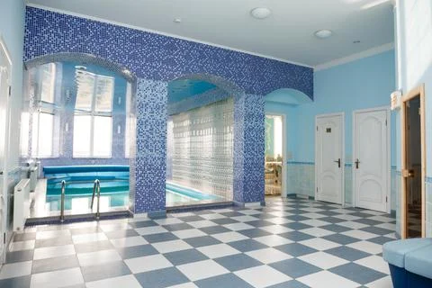 Swimming pool in the pool. Swimming pool with stair and wooden deck. Stock Photos