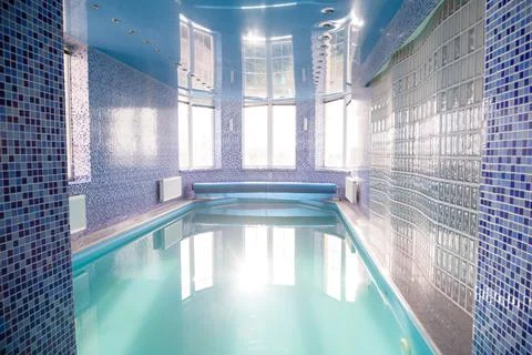 Swimming pool in the pool. Swimming pool with stair and wooden deck. Stock Photos