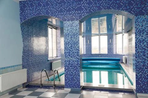 Swimming pool in the pool. Swimming pool with stair and wooden deck. Stock Photos