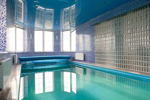 Swimming pool in the pool. Swimming pool with stair and wooden deck. Stock Photos