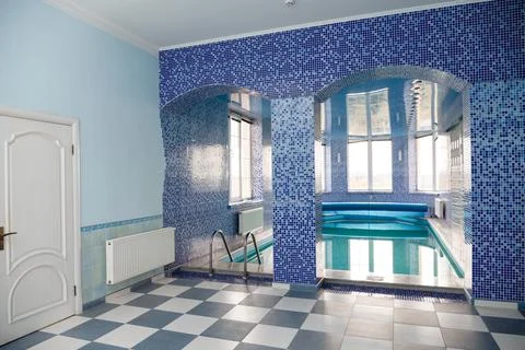 Swimming pool in the pool. Swimming pool with stair and wooden deck. Stock Photos