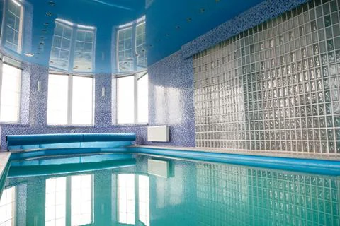 Swimming pool in the pool. Swimming pool with stair and wooden deck. Stock Photos