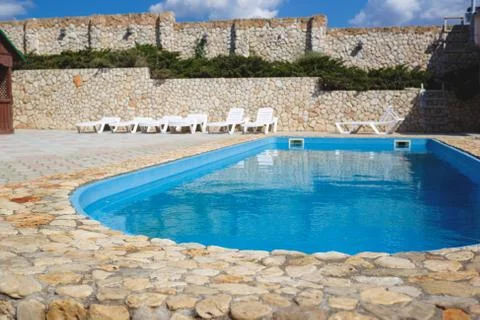 Swimming pool in a recreation area in a rustic resort Stock Photos