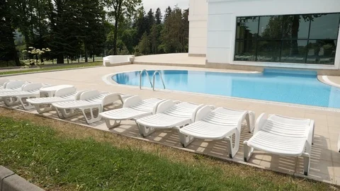 Swimming pool in the recreation complex beach sun beds Stock Footage 103854099