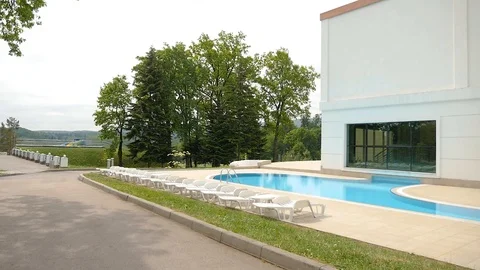 Swimming pool in the recreation complex beach sun beds Stock Footage 103854142