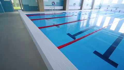 Swimming pool shows competitive lanes under natural lighting Stock Footage 335217396