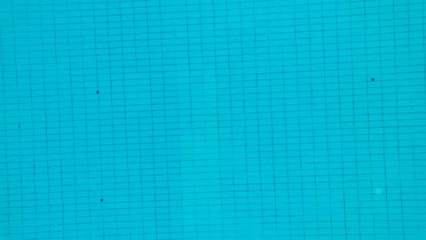 A swimming pool at sunset. Vertical video, the camera moves away aerial video. Stock Footage 71042556