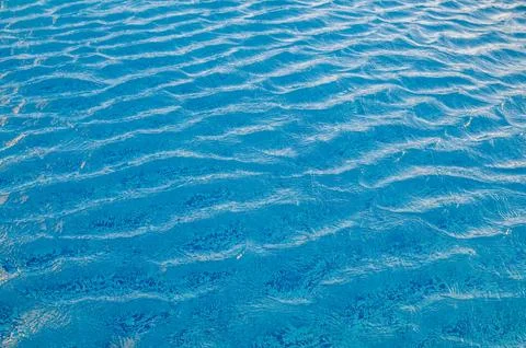Swimming Pool Surface With Light Reflection and Water Ripple Patterns Stock Photos