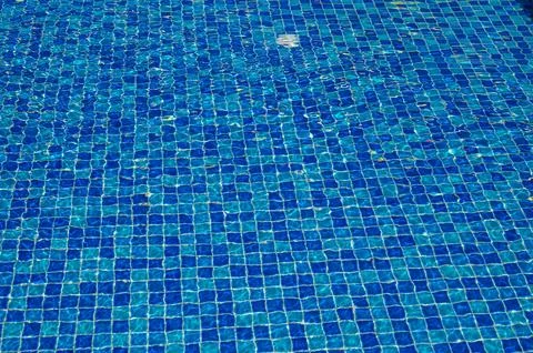 Swimming Pool Surface With Light Reflection and Water Ripple Patterns Stock Photos