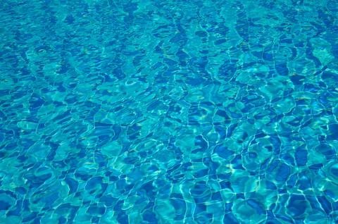 Swimming Pool Surface With Light Reflection and Water Ripple Patterns Stock Photos