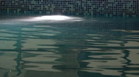 Swimming pool surface with reflection. Dark atmosphere background loop. UHD 4 Stock Footage 52670346