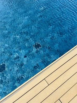 Swimming pool top view background with wood terrace Stock Photos