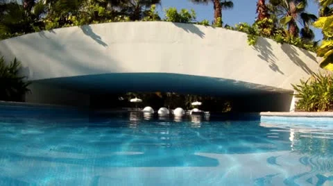 Swimming pool tropical resort float under foot bridge HD 0079 Stock Footage 12524724