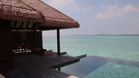 Swimming pool in a villa overlooking the ocean of the Maldives Stock Footage 244150377
