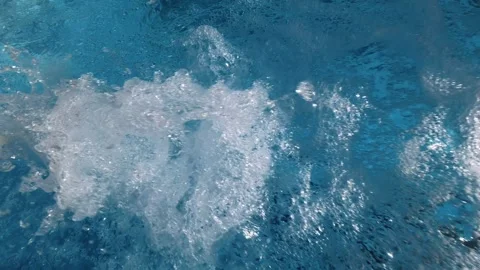 Swimming Pool Water Bubbles and Ripples from Return Outlet Stockbeeldmateriaal 340899618