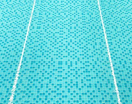 Swimming pool water creating abstract lines on turquoise tiles Stock Photos