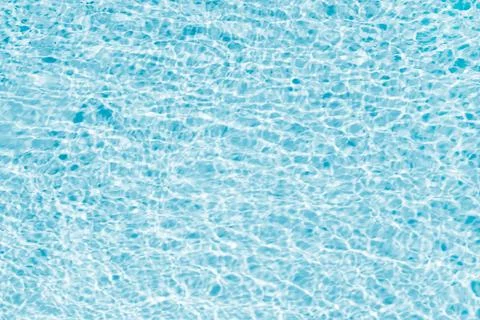 Swimming pool water surface background. Blue, bright and rippled water surf.. Stock-Fotos