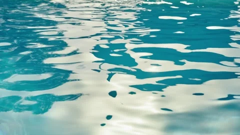 Swimming pool water waves move in pattern in outdoor patio or private pool Stock Footage 308669501