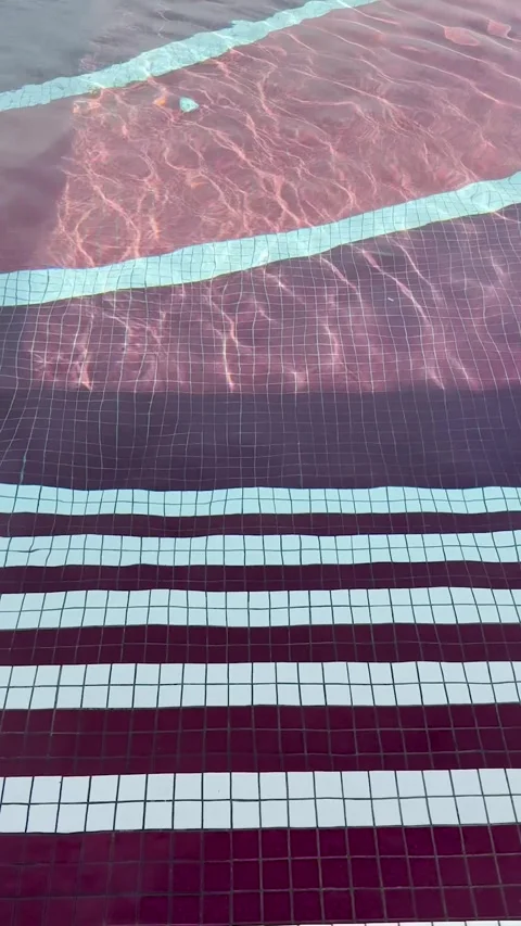 Swimming pool water waves move in pattern in the sunlight. Vertical video. Stock Footage 317367958