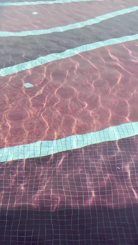 Swimming pool water waves move in pattern and ripples shine in the sunlight. Stock Footage 317732866