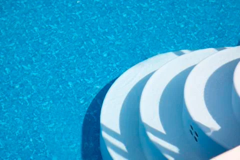 Swimming pool white steps Stock Photos
