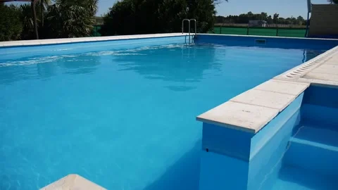 Swimming pool without people, blue, wind and sunny day. Stock Footage 154307648