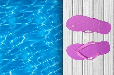 Swimming pool, wooden deck and pink beach shoes Stock Photos