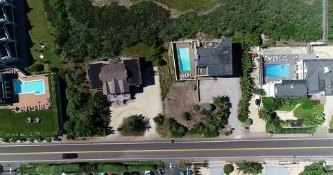 Swimming pools and dune scrub beside Dune Road, Westhampton Beach Stock Footage 91998756